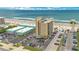 Aerial view of a beachfront condo building with ample parking and ocean views, perfect for coastal living at 3647 S Atlantic Ave # 7C, Daytona Beach, FL 32118