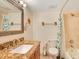 Bathroom featuring a granite topped vanity and tub with shower at 3647 S Atlantic Ave # 7C, Daytona Beach, FL 32118