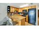 Galley kitchen includes updated appliances, breakfast bar and ample cabinet space at 3647 S Atlantic Ave # 7C, Daytona Beach, FL 32118