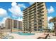 Resort style pool with ample seating located adjacent to the building at 3647 S Atlantic Ave # 7C, Daytona Beach, FL 32118