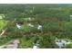Aerial view of property boundaries highlighting the pond, wooded land, and two homes at 3671 Plantation Dr, Ormond Beach, FL 32174