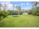 Expansive backyard with a trampoline and ample green space, ideal for recreation and outdoor enjoyment at 3671 Plantation Dr, Ormond Beach, FL 32174