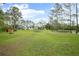 Expansive backyard featuring a home, a pool, and a charming pond, perfect for outdoor enjoyment at 3671 Plantation Dr, Ormond Beach, FL 32174