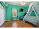 Bedroom with a bed with netting, mint green walls and tile floors at 3671 Plantation Dr, Ormond Beach, FL 32174
