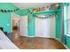 View of a bedroom with mint green walls and decorated with flower garlands at 3671 Plantation Dr, Ormond Beach, FL 32174