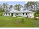 Well maintained single story home with a manicured lawn and mature landscaping at 3671 Plantation Dr, Ormond Beach, FL 32174