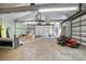 Bright garage with an open layout, suitable for various uses, including a workshop and storage at 3671 Plantation Dr, Ormond Beach, FL 32174