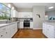 Bright kitchen featuring white cabinetry, stainless steel appliances, and granite countertops at 3671 Plantation Dr, Ormond Beach, FL 32174