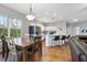 Well lit kitchen and dining area with hardwood table, island with barstools, and stainless appliances at 3671 Plantation Dr, Ormond Beach, FL 32174