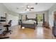 Spacious main bedroom featuring a ceiling fan, desk, and large windows with natural light and exterior views at 3671 Plantation Dr, Ormond Beach, FL 32174