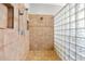 Modern tile shower with a glass block partition providing a clean and stylish design at 3671 Plantation Dr, Ormond Beach, FL 32174