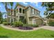 Inviting two-story home with a lush, landscaped front yard and stone accents at 3839 Calliope Ave, Port Orange, FL 32129