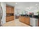 Open-concept kitchen features wood cabinets and stainless steel appliances at 3839 Calliope Ave, Port Orange, FL 32129