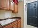 Convenient laundry area with ample cabinet space and a utility sink near the back door at 3839 Calliope Ave, Port Orange, FL 32129