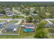 High-angle aerial view of a house with a pool and solar panels, nestled among mature trees in a neighborhood at 4 Brandy Hills Dr, Port Orange, FL 32129