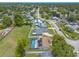 Scenic aerial view of a home with a screened pool and solar panels in a lush, tree-lined neighborhood at 4 Brandy Hills Dr, Port Orange, FL 32129