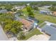 Aerial view of the home with a screened pool, white fence, and well-manicured lawn at 4 Brandy Hills Dr, Port Orange, FL 32129