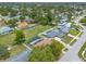 Aerial view of a residential neighborhood with a home featuring a fenced backyard and screened pool at 4 Brandy Hills Dr, Port Orange, FL 32129