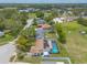 Home aerial view featuring a screened pool with solar panels in a neighborhood surrounded by greenery at 4 Brandy Hills Dr, Port Orange, FL 32129