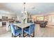 Bright open-concept dining area with kitchen island access and an adjoining living room and fireplace at 4 Brandy Hills Dr, Port Orange, FL 32129