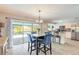 Charming dining area with sliding glass doors, bright lighting, and a view to the backyard and lanai at 4 Brandy Hills Dr, Port Orange, FL 32129