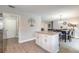 Kitchen island with granite countertops, dining area, and an open floorplan to the dining and living room at 4 Brandy Hills Dr, Port Orange, FL 32129
