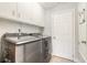 Convenient laundry room with modern Samsung washer and dryer, storage cabinets, and easy access to other areas at 4 Brandy Hills Dr, Port Orange, FL 32129