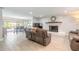 Spacious living room featuring tile floors, a brick fireplace and sliding glass doors to the lanai at 4 Brandy Hills Dr, Port Orange, FL 32129