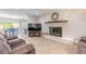 Bright and spacious living room with a whitewashed brick fireplace and comfortable seating arrangement at 4 Brandy Hills Dr, Port Orange, FL 32129