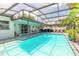 Outdoor pool area with covered patio, ample seating, grill, and a refreshing swimming pool for outdoor enjoyment at 4 Brandy Hills Dr, Port Orange, FL 32129