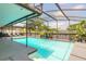 Beautiful pool with screened enclosure, lush greenery, and ample space for relaxation and entertainment at 4 Brandy Hills Dr, Port Orange, FL 32129