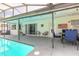Outdoor patio featuring a cozy seating area and dining table next to the pool, great for Gathering gatherings at 4 Brandy Hills Dr, Port Orange, FL 32129