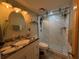 Modern bathroom with granite countertop, stylish fixtures, and a glass-enclosed shower at 411 N Halifax Ave # 208, Daytona Beach, FL 32118