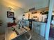 Inviting dining area with stainless steel chairs and a bar area for entertaining at 411 N Halifax Ave # 208, Daytona Beach, FL 32118