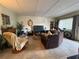 Spacious living room with tile flooring, neutral decor, and ample seating at 411 N Halifax Ave # 208, Daytona Beach, FL 32118