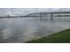 Expansive water view showcasing a bridge, calm waters, and distant buildings under a cloudy sky at 411 N Halifax Ave # 208, Daytona Beach, FL 32118