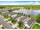 Aerial view of the neighborhood showcasing the lake with a fountain and mature trees at 422 Armoyan Way, New Smyrna Beach, FL 32168