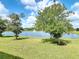 Scenic backyard with a tranquil lake and fountain view, perfect for relaxation and enjoyment at 422 Armoyan Way, New Smyrna Beach, FL 32168