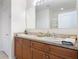 Bathroom showcasing double vanity with granite countertops and updated fixtures for a modern aesthetic at 422 Armoyan Way, New Smyrna Beach, FL 32168