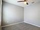 A cozy bedroom featuring neutral walls, plush carpet flooring, and a modern ceiling fan at 422 Armoyan Way, New Smyrna Beach, FL 32168