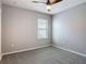 Bedroom features neutral walls, ceiling fan, carpet, and window with blinds providing natural light at 422 Armoyan Way, New Smyrna Beach, FL 32168
