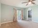 Carpeted bedroom with neutral paint features ceiling fan and sliding glass door leading to patio area at 422 Armoyan Way, New Smyrna Beach, FL 32168