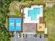 Aerial view of community amenities: a pool, tennis courts, parking, and playground at 422 Armoyan Way, New Smyrna Beach, FL 32168