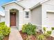 Inviting front entrance with a beautiful landscape and walkway leading to the front door at 422 Armoyan Way, New Smyrna Beach, FL 32168