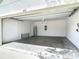 Empty garage with concrete flooring, water heater, and garage door at 422 Armoyan Way, New Smyrna Beach, FL 32168