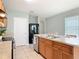 Spacious kitchen with black appliances, wood cabinets and a large island with a sink at 422 Armoyan Way, New Smyrna Beach, FL 32168