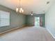 Open-concept living room features carpeted floors, a ceiling fan, and sliding glass doors to the outside at 422 Armoyan Way, New Smyrna Beach, FL 32168