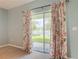 A view from the sliding glass doors of a carpeted room show a fountain and pond at 422 Armoyan Way, New Smyrna Beach, FL 32168