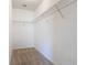 Spacious walk-in closet with wire shelving, carpeted floor, and ample storage for clothing and accessories at 422 Armoyan Way, New Smyrna Beach, FL 32168
