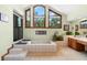 Well-lit bathroom features a shower, large tub, and multiple windows offering scenic backyard views at 43350 Natchez St, Deland, FL 32720